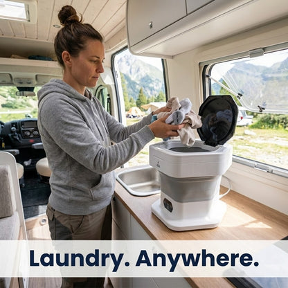 Person using a portable washing machine inside an RV with scenic background